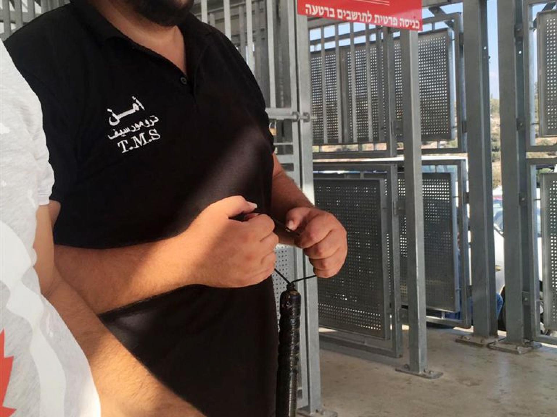 The Barta'a checkpoint: Palestinian security guard armed with club