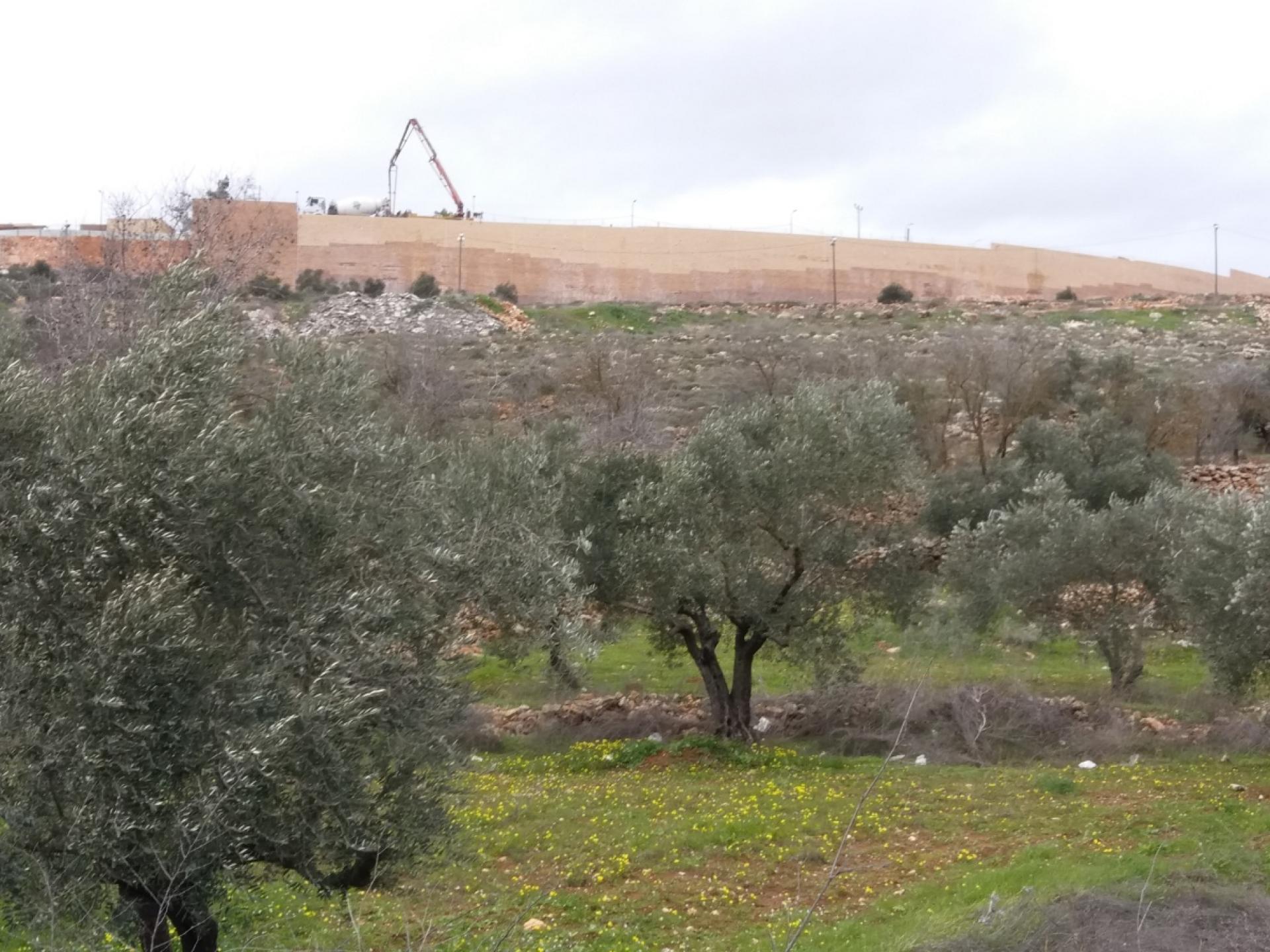 The wall hides the massive construction in the settlement of Rehelim 