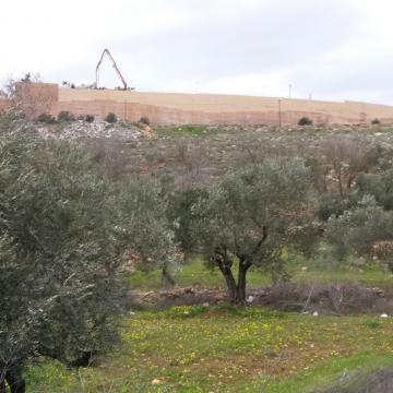 The wall hides the massive construction in the settlement of Rehelim 