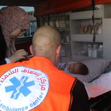 Ali, his mother and the medical staff member in the ambulance