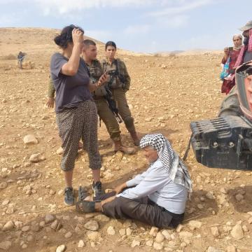 Jordan Valley, Frasia. The Palestinian owner of the land sits in front of the setler's tractor 