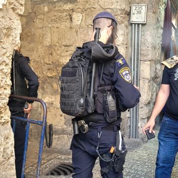 Jerusalem: A policeman makes sure to stop people rushing to prayer